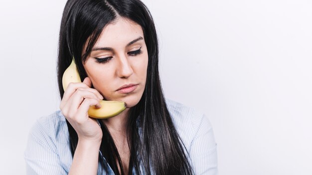 Mujer hablando por teléfono de plátano