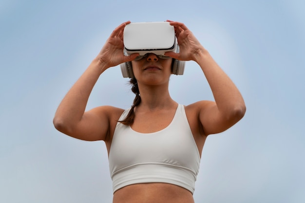 Foto gratuita mujer haciendo ejercicio al aire libre en la naturaleza con gafas vr