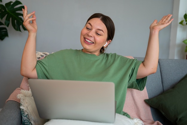 Foto gratuita mujer haciendo una llamada de video en casa en un dispositivo portátil