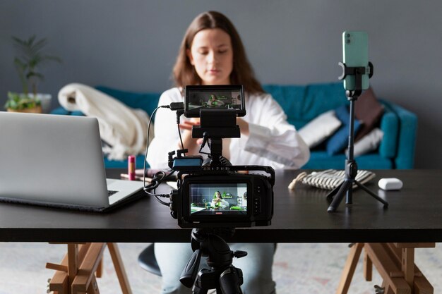 Mujer haciendo un vlog de belleza con su cámara profesional