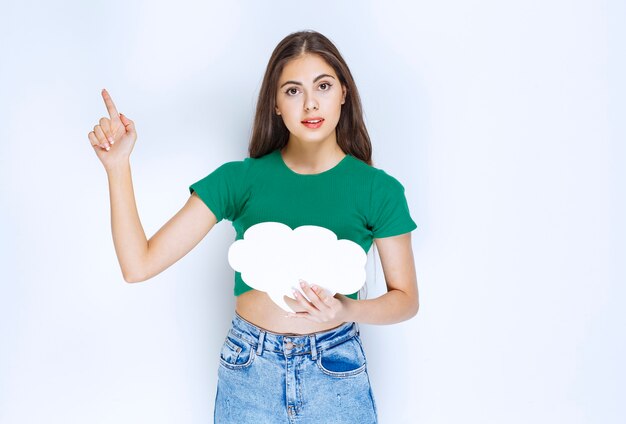 Mujer hermosa joven en camisa verde con discurso de burbuja sobre fondo blanco.