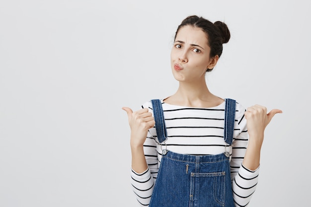 Foto gratuita mujer indecisa apuntando hacia los lados inseguro