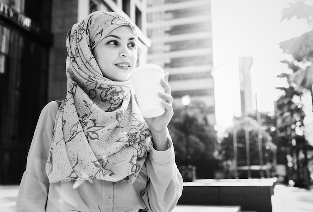 Foto gratuita mujer islámica tomando café en la ciudad