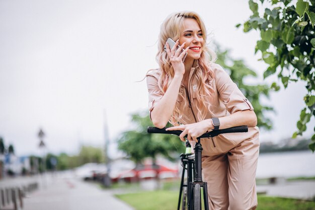 Mujer joven en una bicicleta en el parque