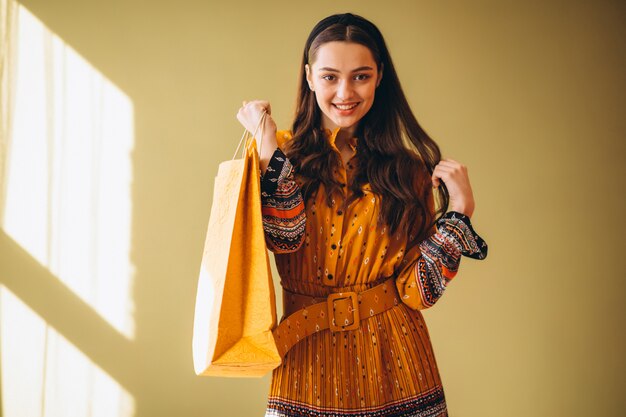 Mujer joven con bolsas de compras en un hermoso vestido