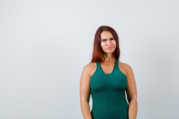 Mujer joven con cabello largo en un bodycon verde