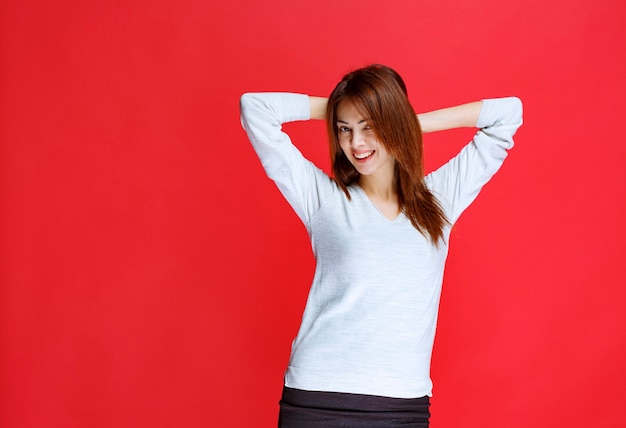 Mujer joven, en, camisa blanca, posición, en, pared roja