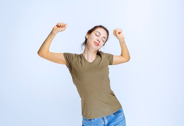 Mujer joven en camisa verde parece somnolienta y cansada