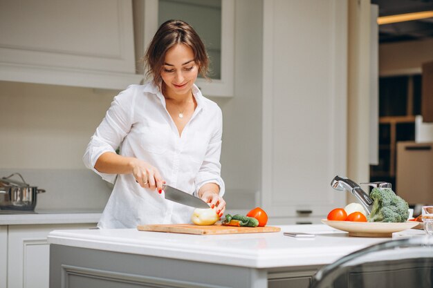 Mujer joven en la cocina preparando el desayuno