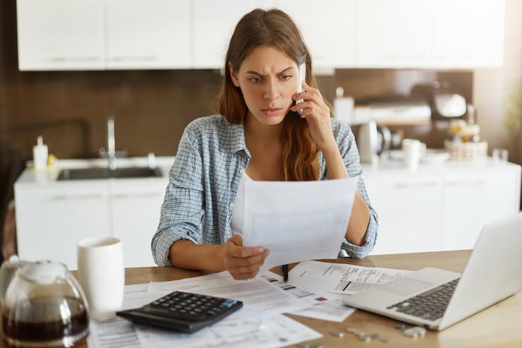 Foto gratuito mujer joven comprobando su presupuesto y haciendo impuestos