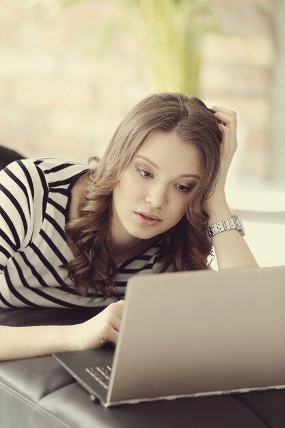 Foto gratuita mujer joven con computadora portátil pc