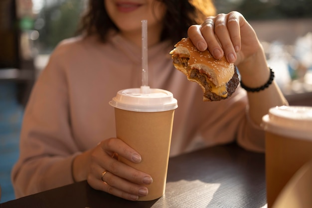 Mujer joven disfrutando de algo de comida en la calle