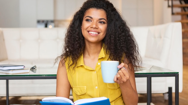 Foto gratuita mujer joven disfrutando de una taza de café