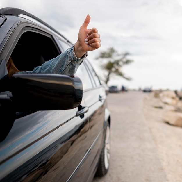 Mujer joven disfrutando de viaje por carretera