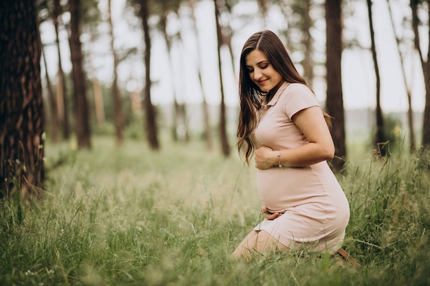 Mujer joven embarazada en un bosque