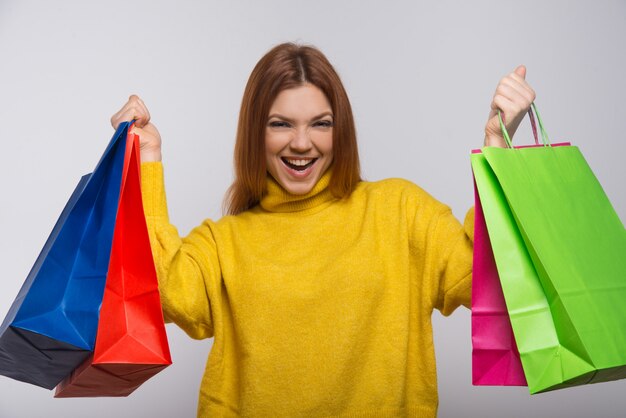 Mujer joven feliz con coloridos bolsos de compras