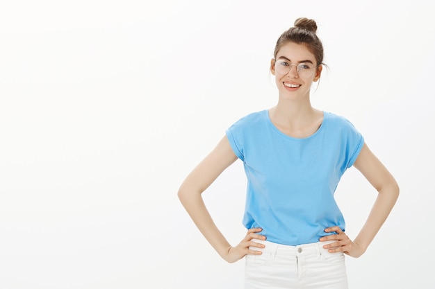 Mujer joven con gafas mirando complacido, listo para los negocios