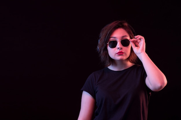 Mujer joven con gafas de sol y camiseta negra