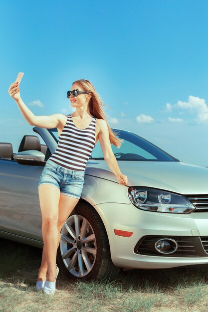 Mujer joven con gafas de sol haciendo autorretrato