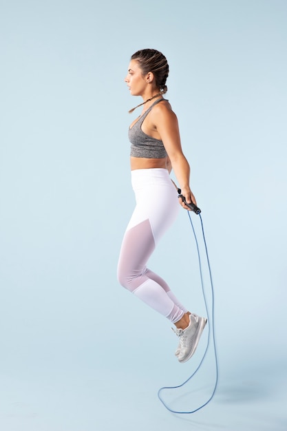 Mujer joven haciendo ejercicio con una cuerda para saltar