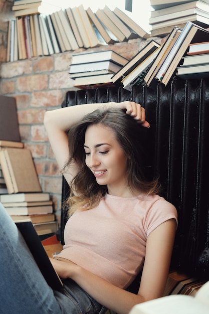 Foto gratuita mujer joven leyendo un libro en casa