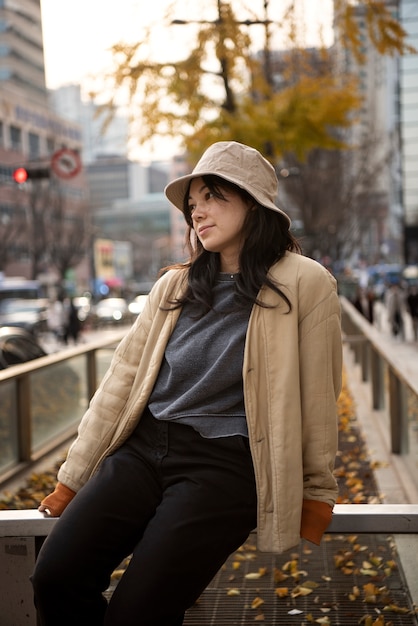 Mujer joven, llevando, un, sombrero del cubo, en la ciudad