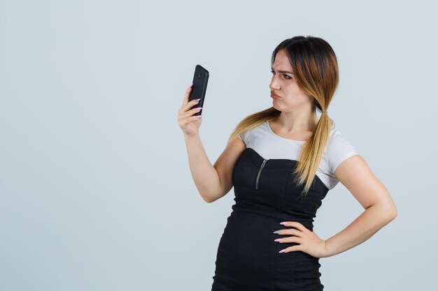 Mujer joven, mirar teléfono móvil