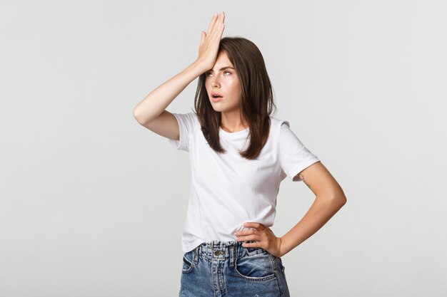 Mujer joven molesta y molesta facepalm y poner los ojos en blanco irritados