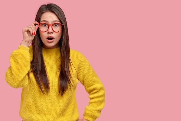 Mujer joven morena en suéter amarillo