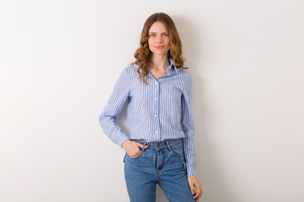 Mujer joven muy elegante posando en traje de estilo denim en blanco