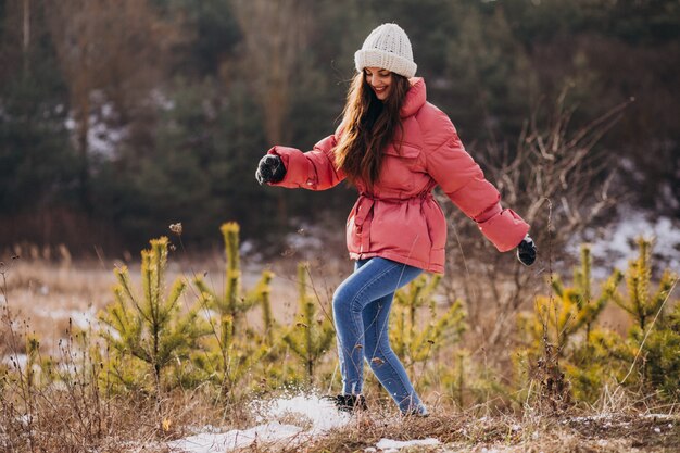 Mujer joven en el parque de invierno feliz