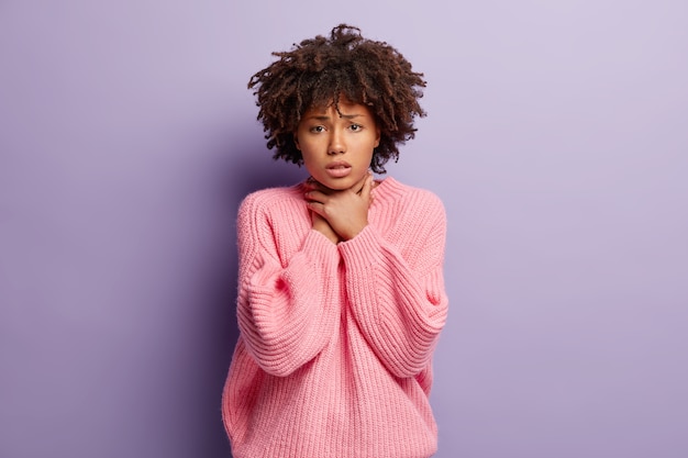 Mujer joven, con, pelo rizado, llevando, rosa, suéter