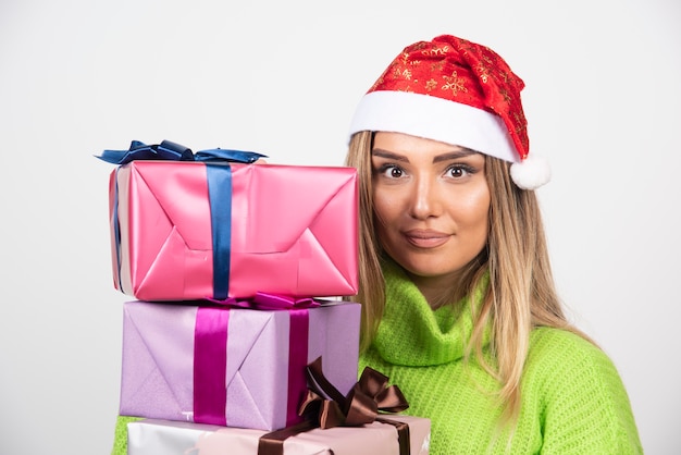 Foto gratuita mujer joven sosteniendo en las manos regalos festivos de navidad.