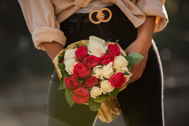 Mujer joven sosteniendo un ramo de rosas de su novio