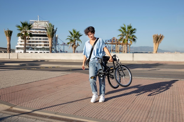 Mujer joven con su bicicleta plegable