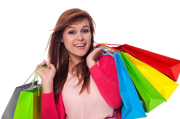 Mujer joven, tenencia, bolsas de compras, y, sonriente