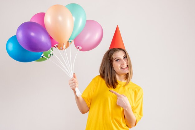 mujer joven, tenencia, colorido, globos, blanco