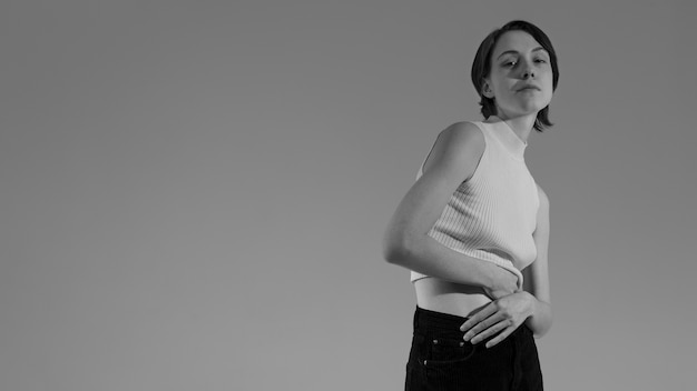 Mujer joven de tiro medio posando en blanco y negro