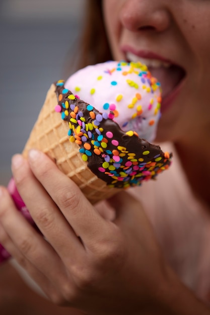 Foto gratuita mujer joven tolerando la ola de calor mientras come un helado