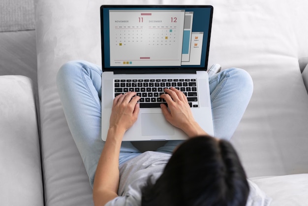 Mujer joven trabajando en su computadora portátil en casa