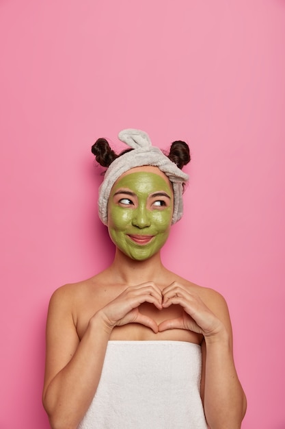 Foto gratuita mujer joven usa tratamientos de piel de mascarilla facial natural después de tomar un baño