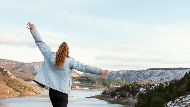 Mujer joven de visión trasera en la naturaleza