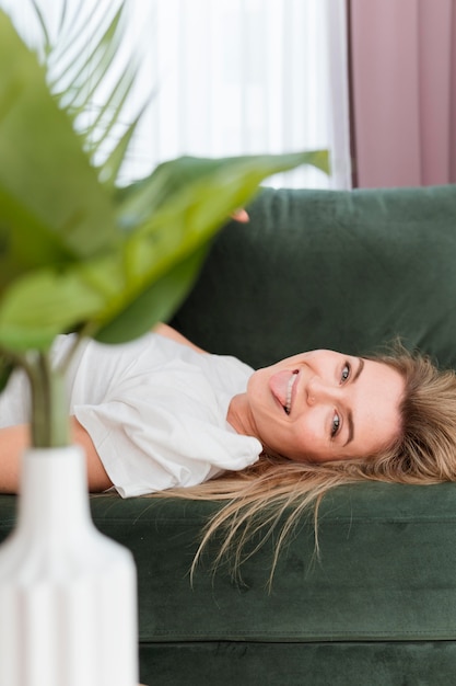 Mujer jugando y planta de primer plano