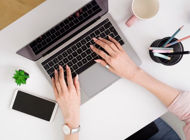 Mujer laica plana que trabaja en la computadora portátil