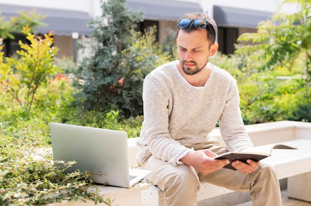 Foto gratuita mujer con laptop y tablet trabajando al aire libre