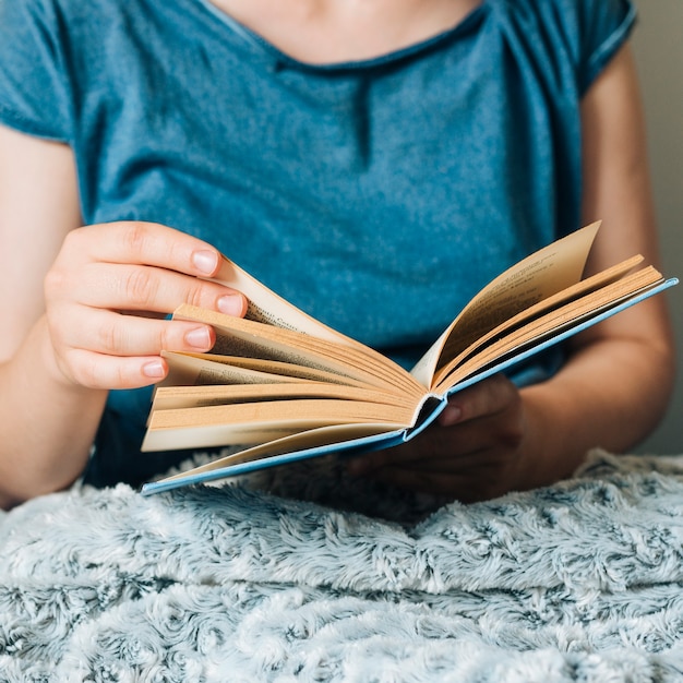 Mujer leyendo un libro en casa