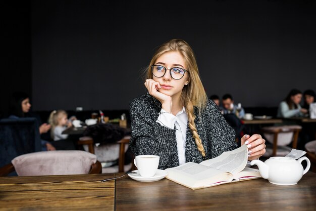 Mujer con libro en café