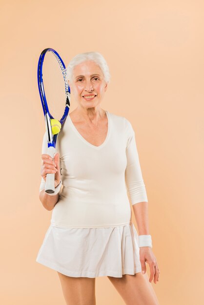 Mujer mayor moderna jugando al tenis