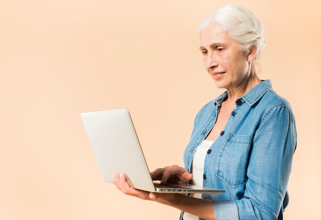 Mujer mayor moderna con portátil