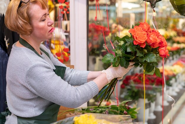 Mujer mayor que sostiene el ramo de la flor